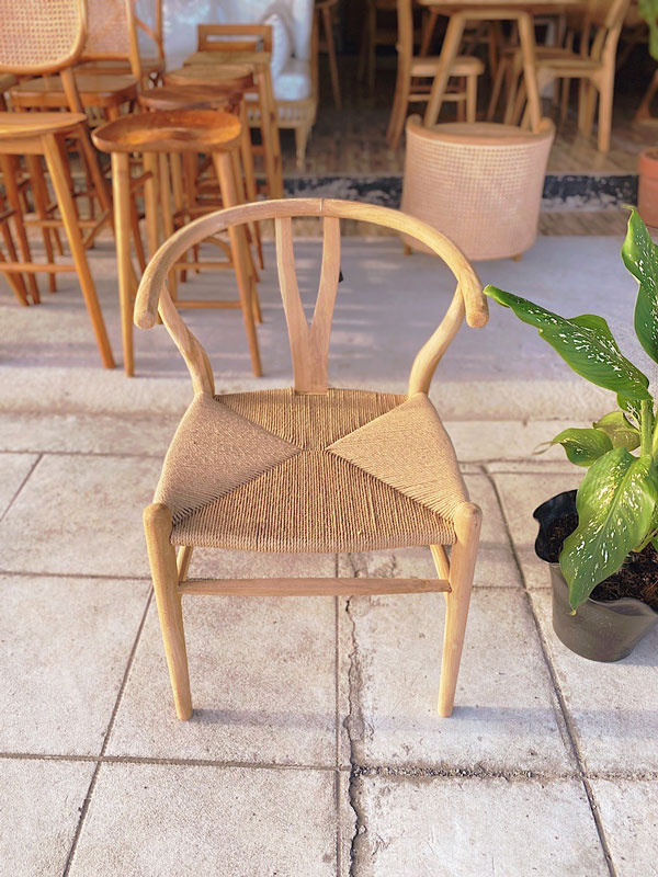 Wishbone chair with a natural wood finish and woven seat, showcasing its elegant, minimalist design