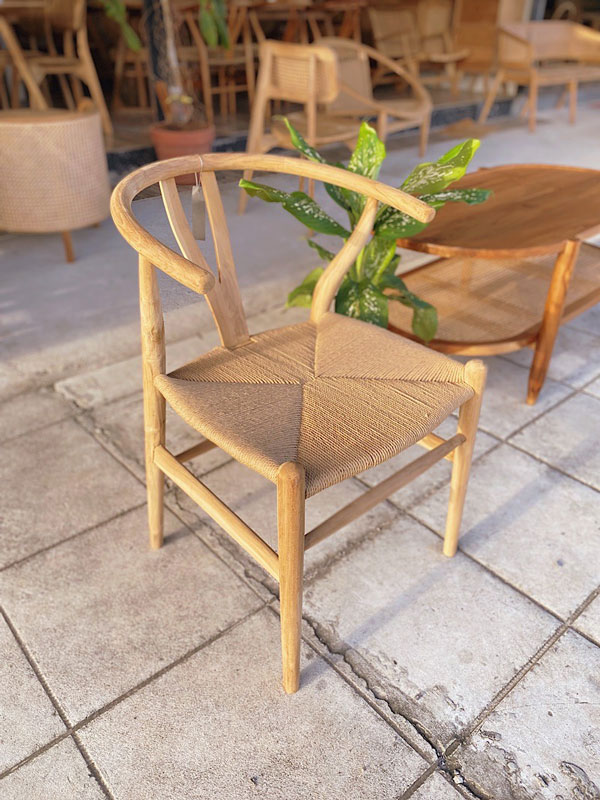 Wishbone chair with a natural wood finish and woven seat, showcasing its elegant, minimalist design